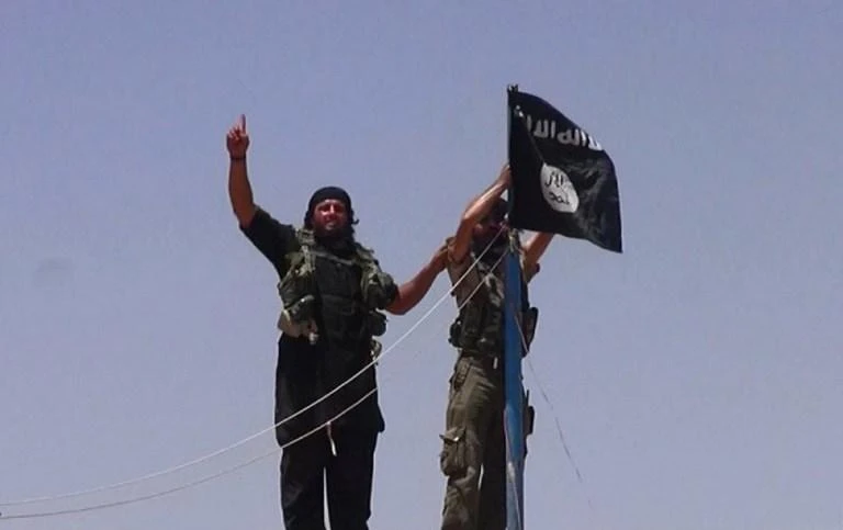 The village of Jizaa in eastern Syria’s Euphrates Valley is one of the very last pockets still controlled by Daesh. Above, Daesh militants raise their flag in Hasakah province in this 2014 picture. (Al-Baraka/AFP)