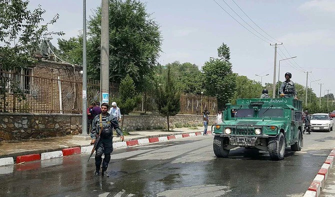 Afghan policemen stand guard near the site of a suicide attack at the gates of Kabul’s Polytechnic University in Kabul on June 4, 2018. (AFP)
