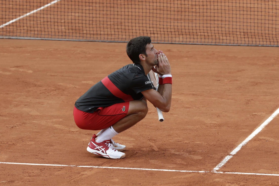 Serbia's Novak Djokovic reacts after missing a shot against Italy's Marco Cecchinato in the tie break of the fourth set of their quarterfinal match at the French Open tennis tournament at the Roland Garros stadium in Paris. (AP Photo/Alessandra Tarantino)