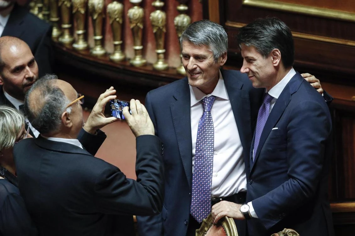Senators take photos with Italian Premier Giuseppe Conte, right, at the Senate, in Rome. Italy’s new populist government won the first of two votes of confidence needed to start governing after its leader denounced Europe’s ‘failed’ immigration policy and warned that his Cabinet would renegotiate Italy’s fiscal obligations so it can help struggling Italians. (AP Photo)