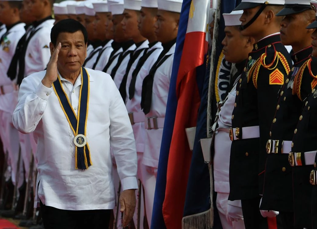 Philippine President Rodrigo Duterte drew widespread condemnation at home after he kissed a married Filipina on the lips in front of thousands of Filipino workers in a town hall meeting in Seoul. (AFP)