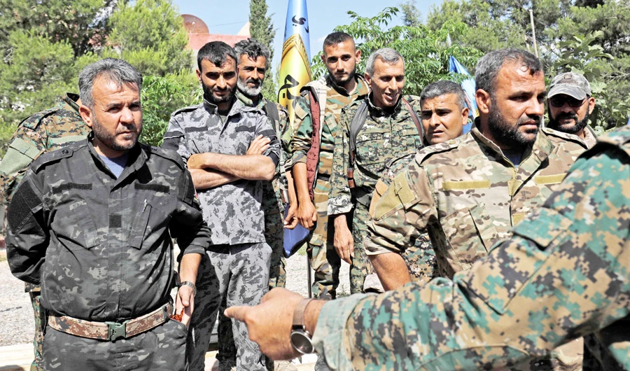 Members of the Manbij military council wait prior to a press conference in Manbij on Wednesday. (AFP)