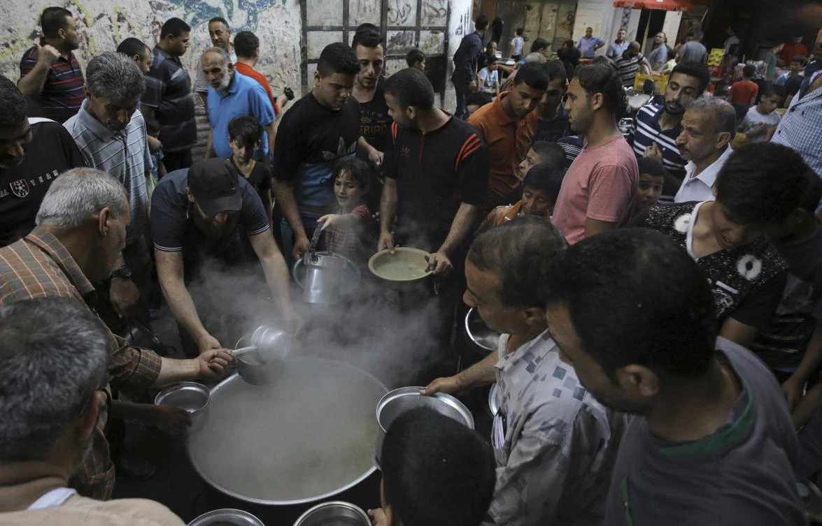 Free porridge is distributed to the poor during the holy fasting month of Ramadan in Gaza City. Growing despair in Gaza has helped drive recent Hamas-led protests against the border blockade by Israel and Egypt. (AP)