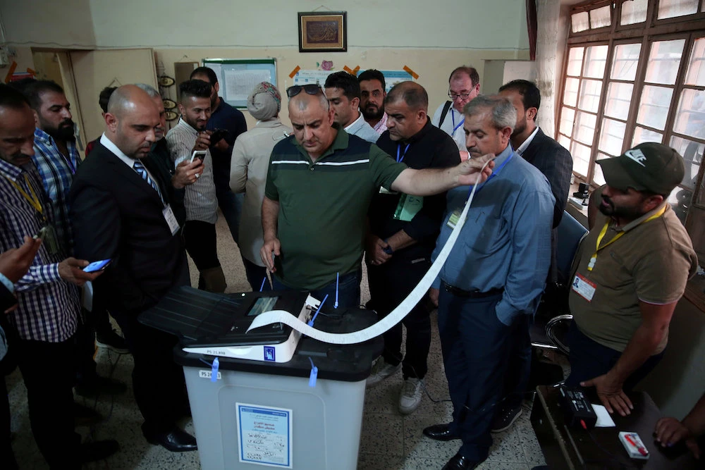 In this file photo, Iraq's Independent High Electoral Commission employee closes a ballot box at a polling station during the parliamentary election in Baghdad, Iraq. (Reuters)