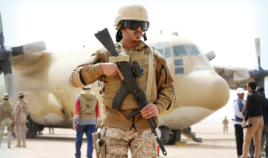 A Saudi soldier stands guard next to a Saudi air force cargo plane delivering aid at an airfield in the northern province of Marib, Yemen. (Reuters/File)