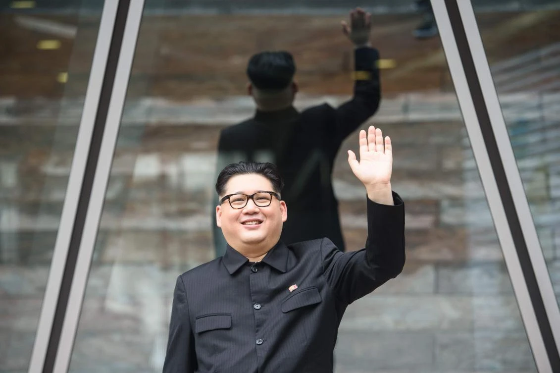 Kim Jong Un impersonator, who goes by the name Howard X, waves while dressed up as the North Korean leader in Hong Kong on June 7. Howard X was told by Singaporean police to stay away from the summit venue between Kim and US President Donald Trump. (AFP)