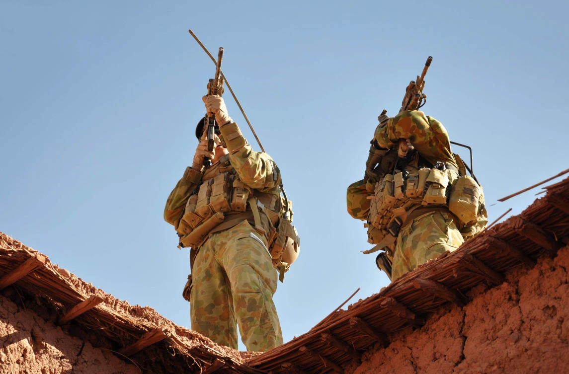 Soldiers from the Special Operations Task Group use their rifle scopes to investigate the surrounding mountains during an operation in southern Afghanistan in this handout photo from the Australian Department of Defence on October 2009. (Australian Department of Defence/AFP)