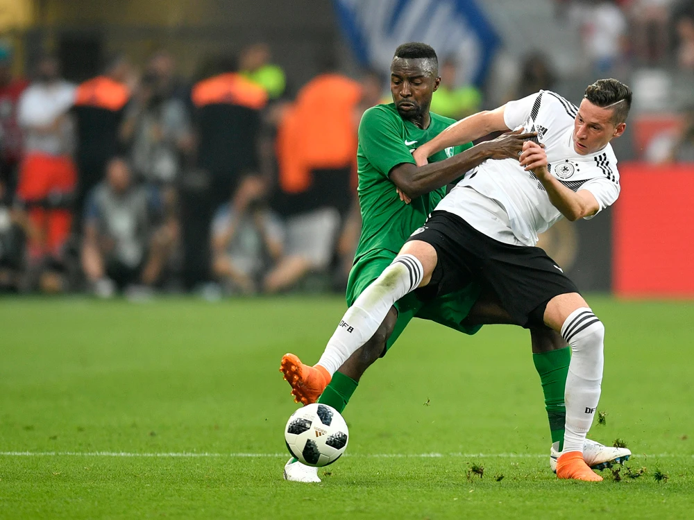 Saudi Arabia’s Osama Hawsawi duels for the ball with Germany’s Julian Draxler during the friendly between Germany and Saudi Arabia at the BayArena in Leverkusen. The eyes of the world will be on Juan Antonio Pizzi’s Saudi side when they play in the opening game of the 21st World Cup against Russia on Thursday. (AFP)