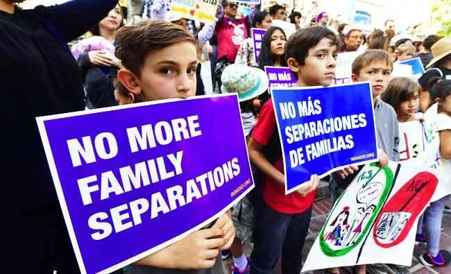 People gather for a rally organized by local families, their supporters and civil rights organizations on the steps of City Hall in Los Angeles, California on Friday, to protest the federal government's enforcement policy to separate children from their parents trying to cross the US-Mexico border illegally. (AFP)