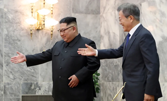 In this May 26, 2018, file photo, provided by South Korea Presidential Blue House via Yonhap News Agency, South Korean President Moon Jae-in, right, is guided by North Korean leader Kim Jong Un, left, at the northern side of Panmunjom in North Korea. (AP)