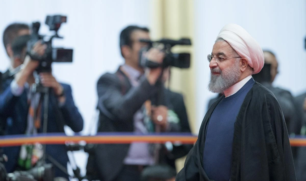 Iranian President Hassan Rouhani walks past the media at the Shanghai Cooperation Organization (SCO) Summit in Qingdao in eastern China's Shandong Province, Sunday, June 10, 2018. (AP)