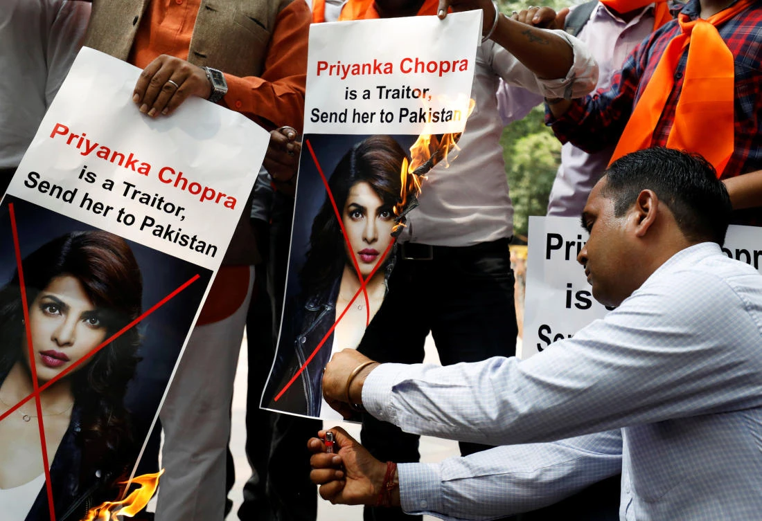 Supporters of Hindu Sena, a right wing Hindu group, burn posters of Bollywood actress Priyanka Chopra during a protest, in New Delhi, India, June 9, 2018. (Reuters)