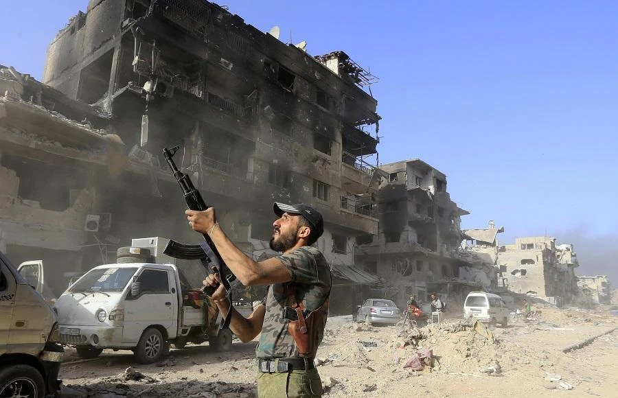 Syrian pro-government soldier fires his weapon. (AFP)