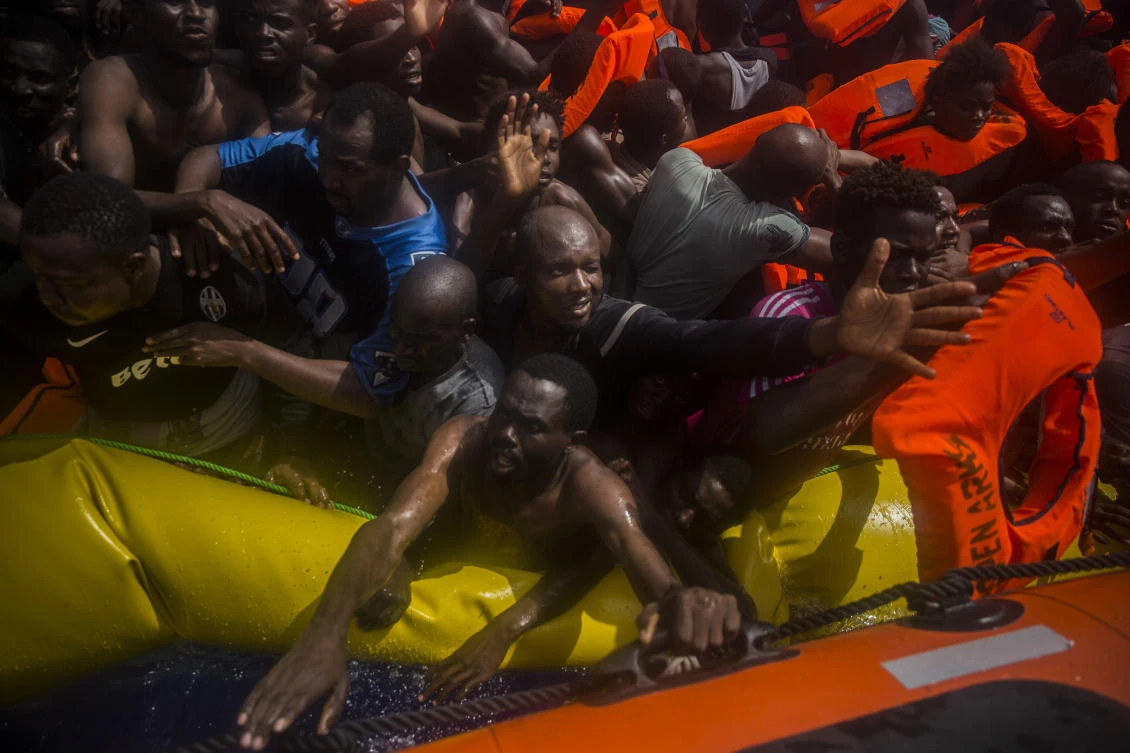 Sub-Saharan migrants receive life jackets as they are rescued by aid workers of Spanish NGO Proactiva Open Arms in the Mediterranean Sea, about 15 miles north of Sabratha, Libya. (AP)
