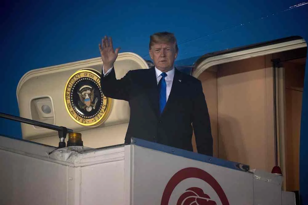 US President Donald Trump walks off Air Force One upon his arrival at Paya Lebar Air Base in Singapore, ahead of his planned meeting with North Korea's leader Kim Jong Un, Singapore, June 10, 2018. (AFP)