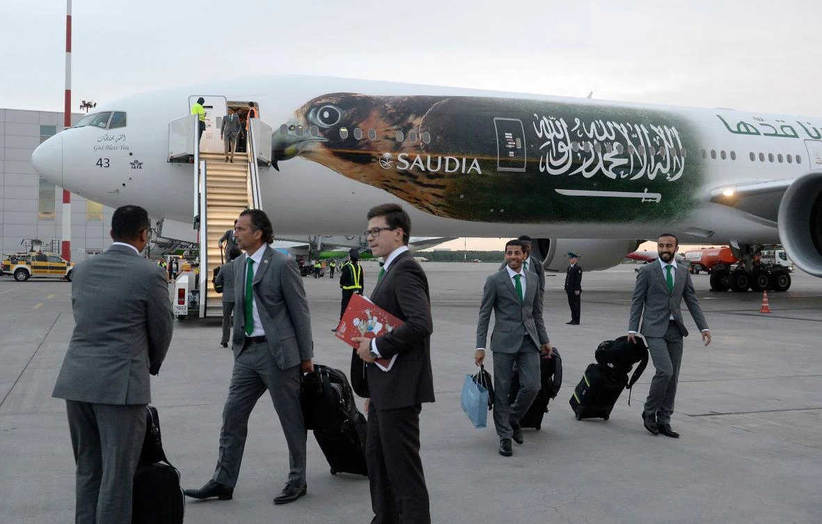 Juan Antonio Pizzi leads the Saudi Arabia party off the plane in Saint Petersburg. (AFP)