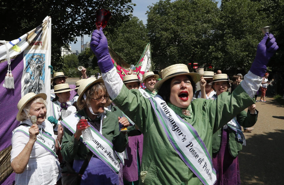 Participants react as they march through the streets to celebrate 100 years since women were granted the vote, in London, Sunday June 10, 2018. (AP)