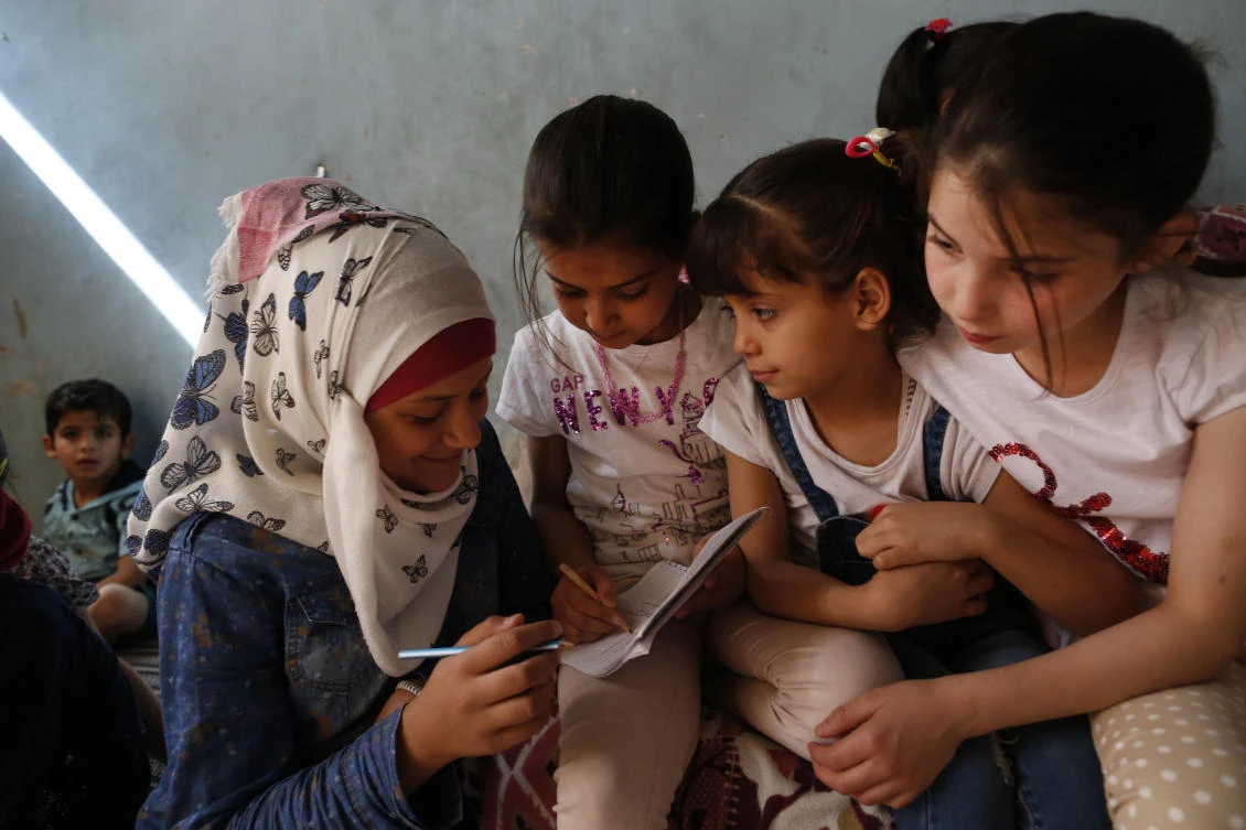 The orphanage first established in rebel-held eastern Aleppo, known as the Center for the Exceptional, has finally landed in a small house in the sleepy northern town of Jarablus. Above, Noor Ghanem, left, helps other Syrian orphans from Aleppo as they study at the orphanage. (AP)