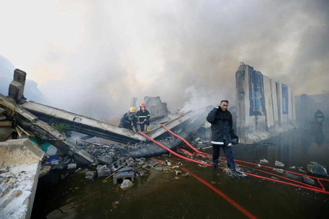 Firefighters inspect after a fire at a storage site in Baghdad, housing the boxes from Iraq's May parliamentary election, Iraq June 10, 2018. (Reuters)