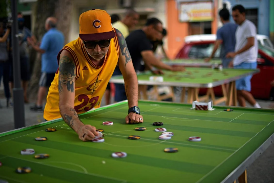 Every weekend, some 20 to 30 players meet in Rio de Janeiro to play with their customized colorful buttons, inspired in teams around the world and in legendary players. (Carl De Souza/AFP)