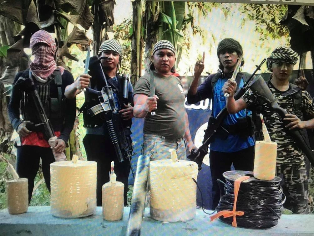 A screen grab from a video supplied by an informant to the military shows Islamist militants, believed to include foreign personalities. Also seen in the picture are bomb making materials. The video was taken inside the BIFF bomb factory destroyed during the military operations on Sunday. (Photo from Army 6ID)