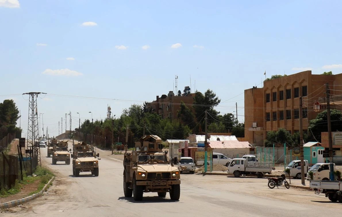 Vehicles from the US-led coalition battling the Daesh group patrol the town of Rmelane in Syria’s Hasakah province on June 5, 2018. (AFP)