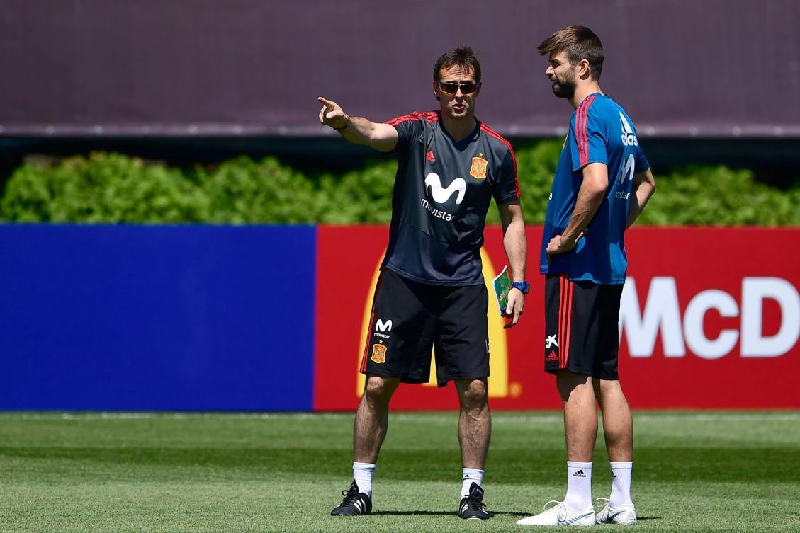 Spain’s coach Julen Lopetegui (L) speaks with defender Gerard Pique during a training session at Krasnodar Academy, ahead of the Russia 2018 World Cup. Real Madrid says Lopetegui will replace Zinedine Zidane as coach of the club after the tournament. (AFP)
