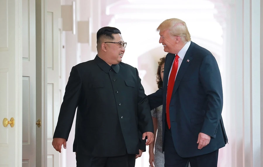 US President Donald Trump (R) and North Korea's leader Kim Jong Un (L) walk to attend their historic US-North Korea summit. (AFP)
