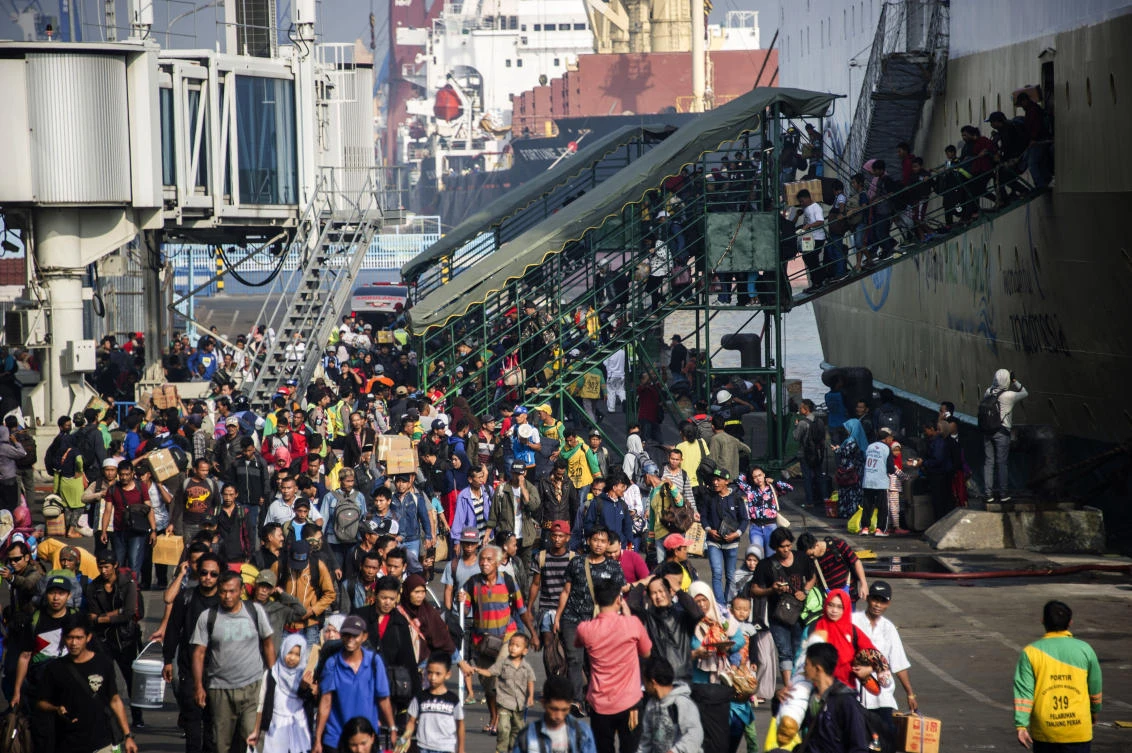 Above, passengers disembark from a ship on arrival at the Surabaya port in East Java on Tuesday, June 11. Cities in the world’s most populous Muslim-majority country empty out every year at the end of Ramadan as people head to villages to celebrate Eid with their families. (AFP)