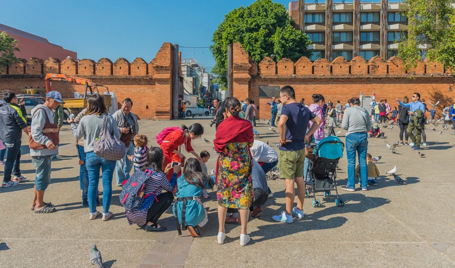 Unrecognizable people and pigeon on street of "Tha Pae" Gate is the most famous landmarks in the city in Chiang Mai, Thailand. (Shutterstock)