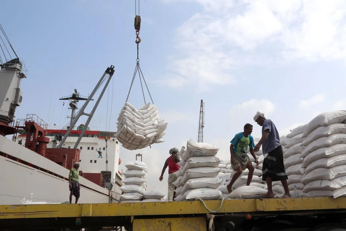 File photo showing workers unloading wheat provided by UNICEF from a cargo ship docked in the western Yemen port of Hodeidah, January 27, 2018. (AFP)