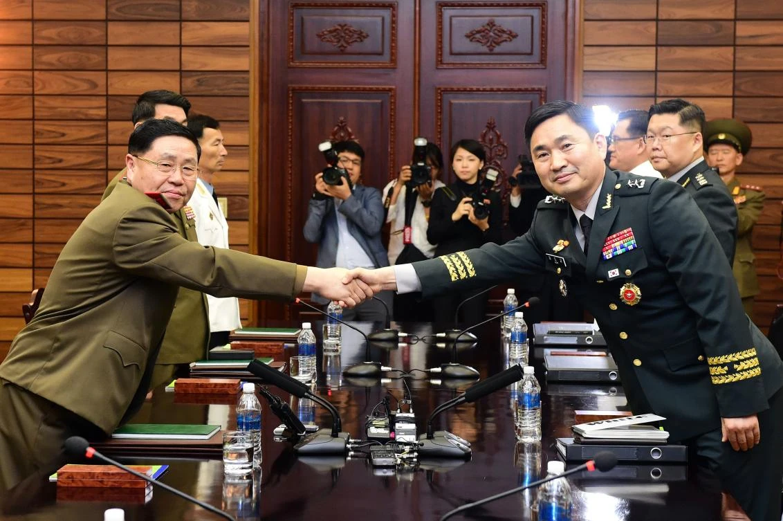 Photo handout photo taken and provided by the South Korean Defense Ministry shows South Korea’s chief delegate Major General Kim Do-gyun (R) shaking hands with his North Korean counterpart An Ik San (L) during their high-level military talks in Panmunjom, the Demilitarized zone (DMZ) dividing the two Koreas, June 14, 2018. (AFP)