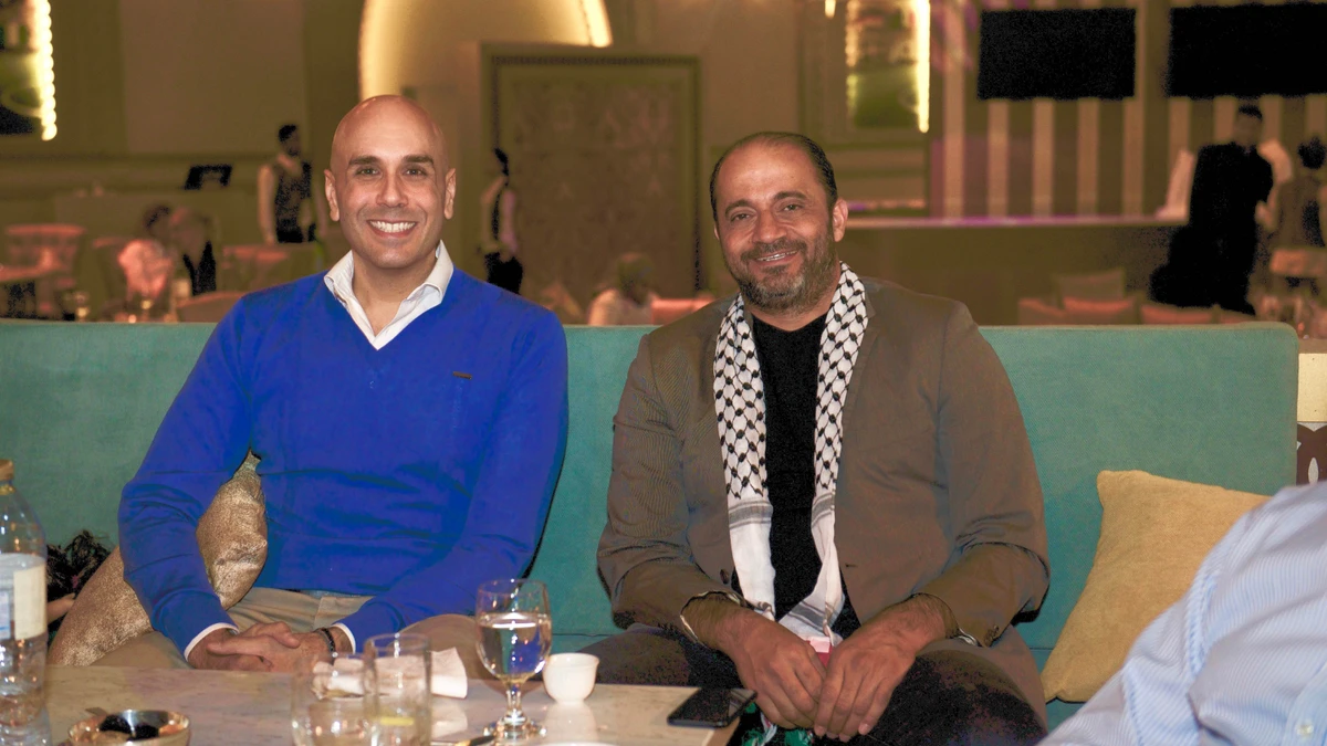 (L) Muhammad Qubbaj, a British/Jordanian expatriate, and (R) Sami Issa, a Palestinian/American, watch as the 2018 Fifa World Cup got under way on Thursday at Emirates Palace. (AN PHOTO)