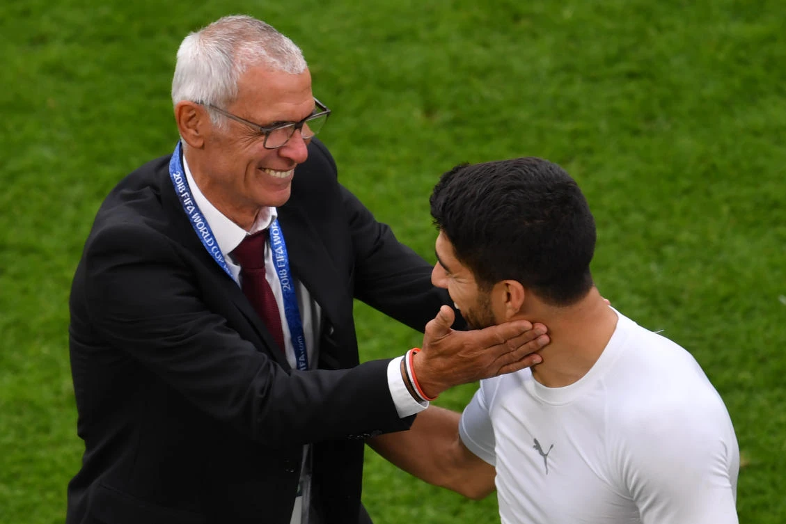 Photo showing Egypt’s coach Hector Raul Cuper (L) being greeted by Uruguay Luis Suarez after the final whistle of the Russia 2018 World Cup Group A football match between Egypt and Uruguay at the Ekaterinburg Arena, Ekaterinburg, June 15, 2018. (AFP)