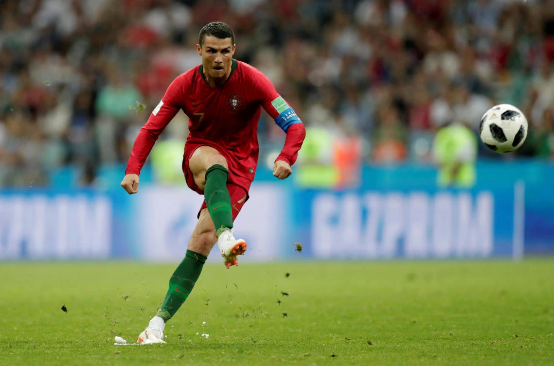 Take that: Portugal’s Cristiano Ronaldo scores with a spectacular free kick to complete his hat-trick against Spain at the Fisht Stadium, in Sochi, on the day he agreed to pay the Spanish taxman €18.8 million. (Reuters)