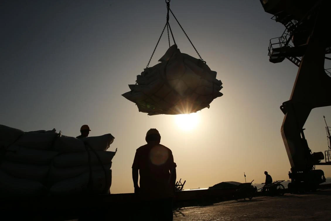 This file photo taken on April 9, 2018 shows workers transferring soybeans at a port in Nantong in China’s eastern Jiangsu province. (AFP)