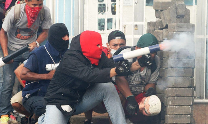 Police and pro-Ortega masked gunmen had fired at protesters guarding the roadblocks. (AP)