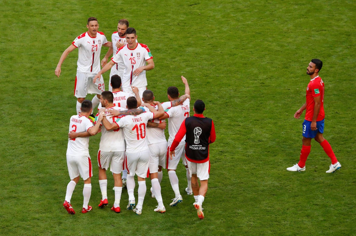 Serbia players celebrate after the match in which Aleksandar Kolarov scored a free-kick to sink Costa Rica. (REUTERS/David Gray)