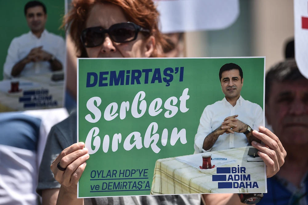 Supporters of the Peoples' Democratic Party (HDP) hold placards reading "Free Demirtas" in front of Istanbul's Courthouse on May 21, 2018, to demand the release of Pro-Kurdish party leader Selahattin Demirtas. (AFP)
