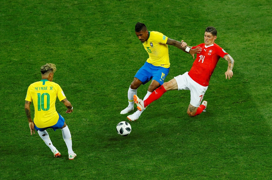 Switzerland's Steven Zuber in action with Brazil's Paulinho and Neymar. (REUTERS/Jason Cairnduff)