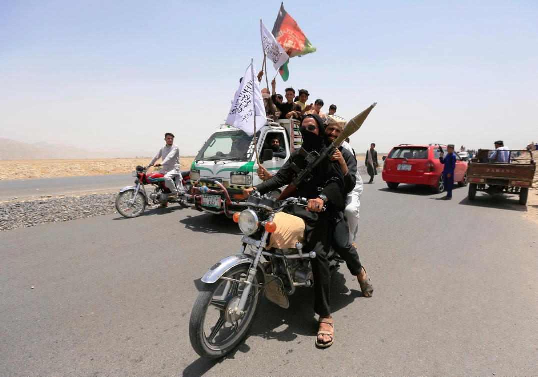 Taliban ride on a motorbike as they celebrate cease-fire in Rodat district of Nangarhar province, Afghanistan June 16, 2018 (Reuters/Parwiz)
