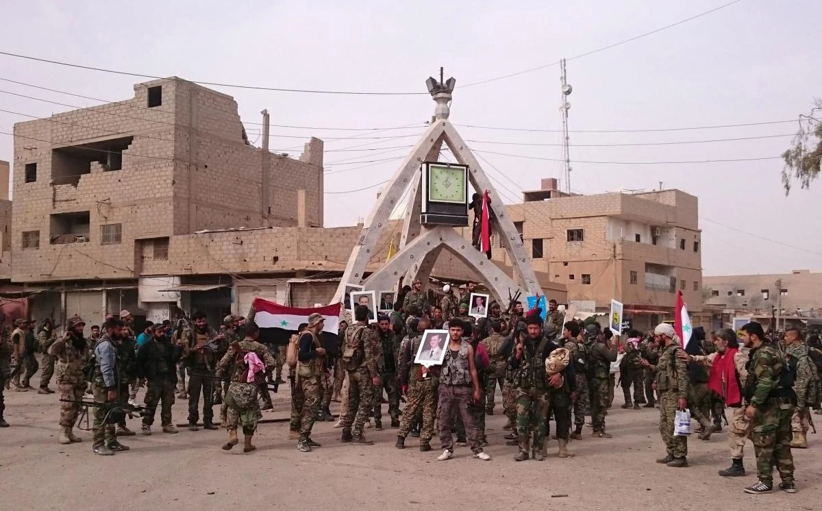 File photo showing Pro-Syrian government fighters gather in Al-Boukamal, eastern Syria. (AFP)