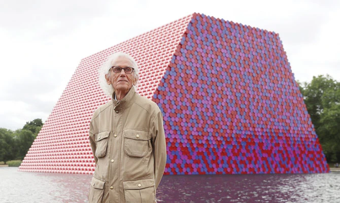 Artist Christo stands in front of his work The London Mastaba, on the Serpentine in Hyde Park, London, on Monday. Reuters