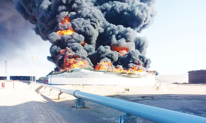 Smoke and flames rise from an oil storage tank that was set on fire amid fighting between rival factions at Ras Lanuf terminal, Libya. Reuters