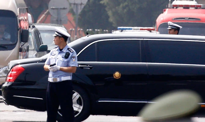 The motorcade that is believed be carrying North Korea leader Kim Jong Un, passes by policemen as it leaves the Beijing Capital International Airport in Beijing, on Tuesday, June 19, 2018. (AP)