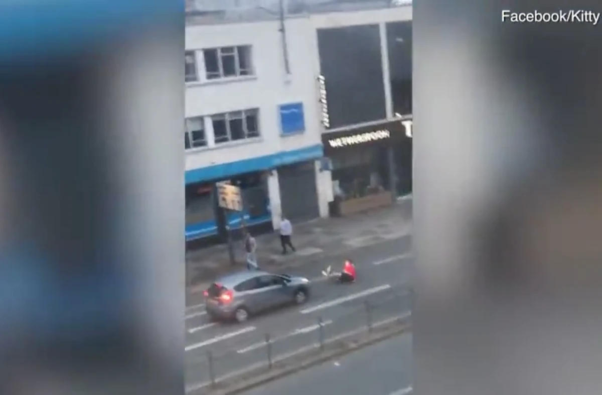 Screen grab of the moment a large England fan decides that mounting the bonnet of a car in celebration of his team's first win was a good idea (YouTube)