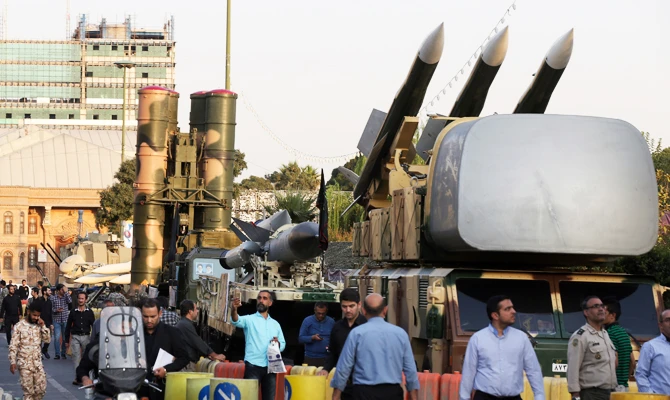 A Russian-made S-300 air defense system, left, is on display for the annual Defense Week, in Tehran, Iran. (AP)