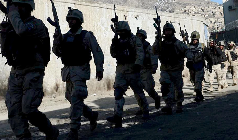 In this file photo, Afghan commandos walk down a road near the Kabul police headquarters building after a clash between Afghanistan forces and Taliban fighters in Kabul. (AFP)