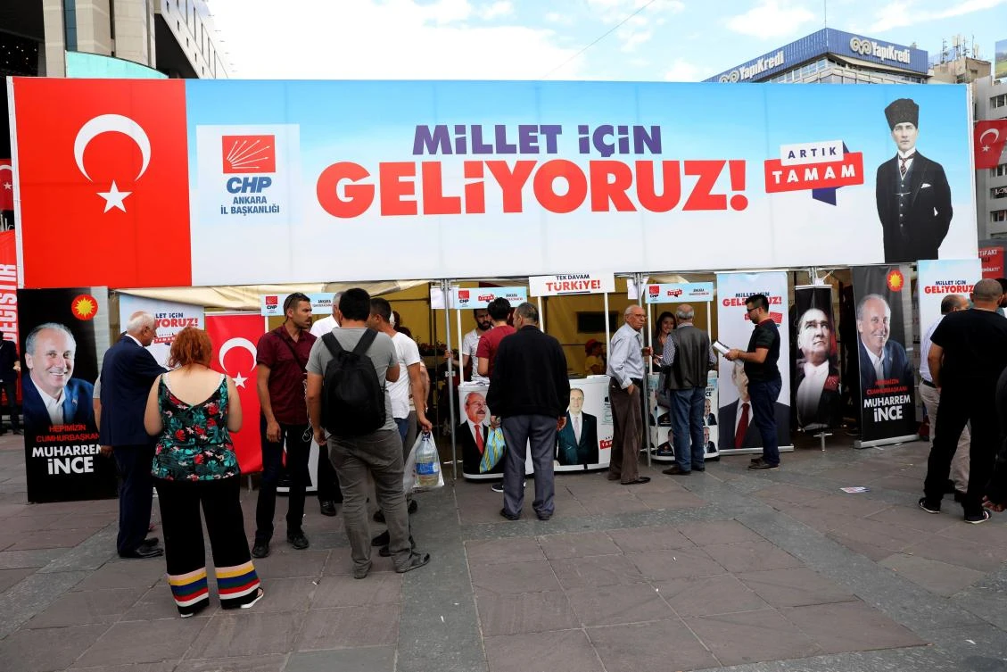 People stand by an electoral campaign tent of the Republican People's Party on June 19, 2018 in Ankara, ahead of June 24the Turkish presidential and parliamentary elections. (AFP)