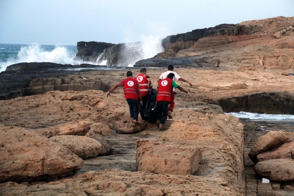 Libyan Red Crescent team members recover bodies of migrants who drowned at sea off the coast of the western city of Janzur on June 19, 2018. (AFP)